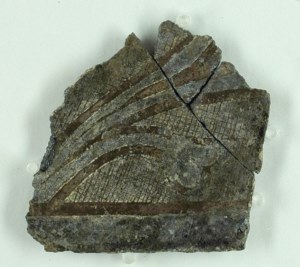 Decorated glass fragment found in excavation.