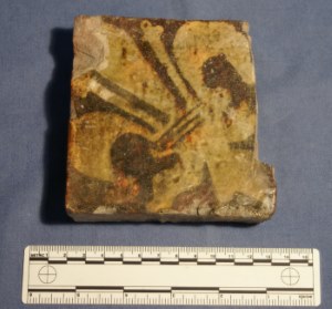 Fleur-de-lys patterned tile.